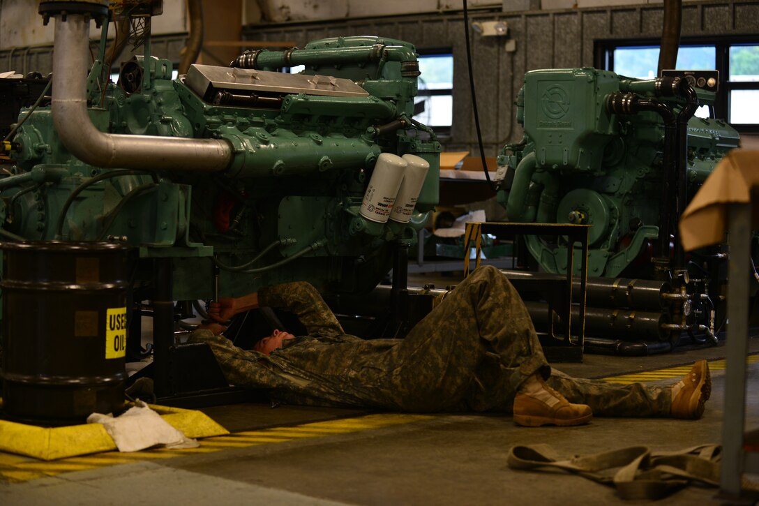 U.S. Army Sgt. Jason Cole, 2nd Staff and Faculty Company Watercraft Engineer Certification Course student, tightens engine parts during an engine rebuild at Fort Eustis, Va., May 21, 2015. Upon completion of the course, students are certified to maintain and repair any Army vessel. (U.S. Air Force photo by Staff Sgt. Natasha Stannard/Released)

