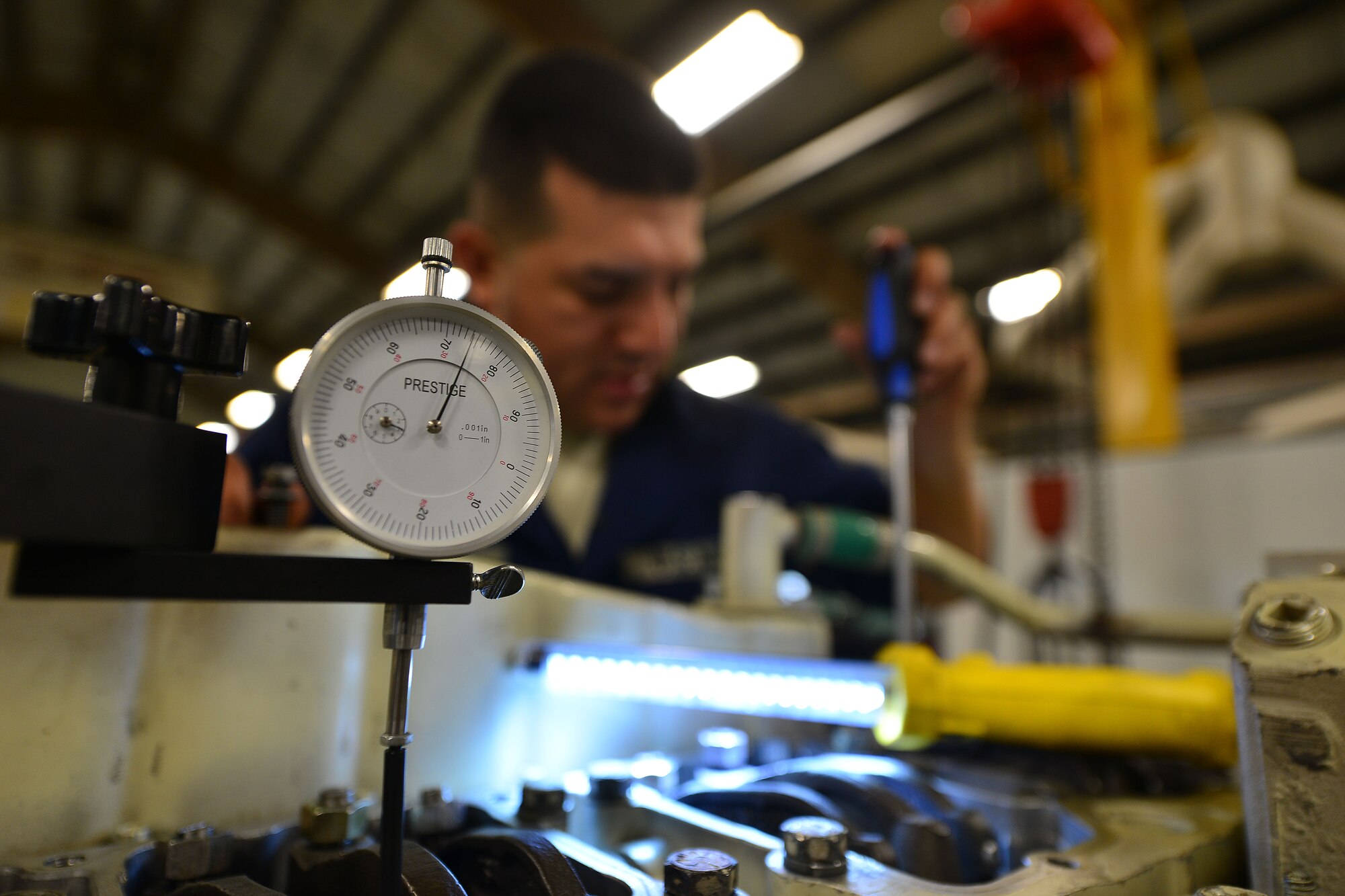U.S. Army Warrant Officer Randy Saucedo, 2nd Staff and Faculty Company Marine Engineering Officer Basic Course student, performs a tune-up on a diesel Landing Craft Utility-2000 generator at Fort Eustis, Va., May 21, 2015. During the tune-up, generator parts must be gauged to exact torque values to prevent serious damage. (U.S. Air Force photo by Staff Sgt. Natasha Stannard/Released)