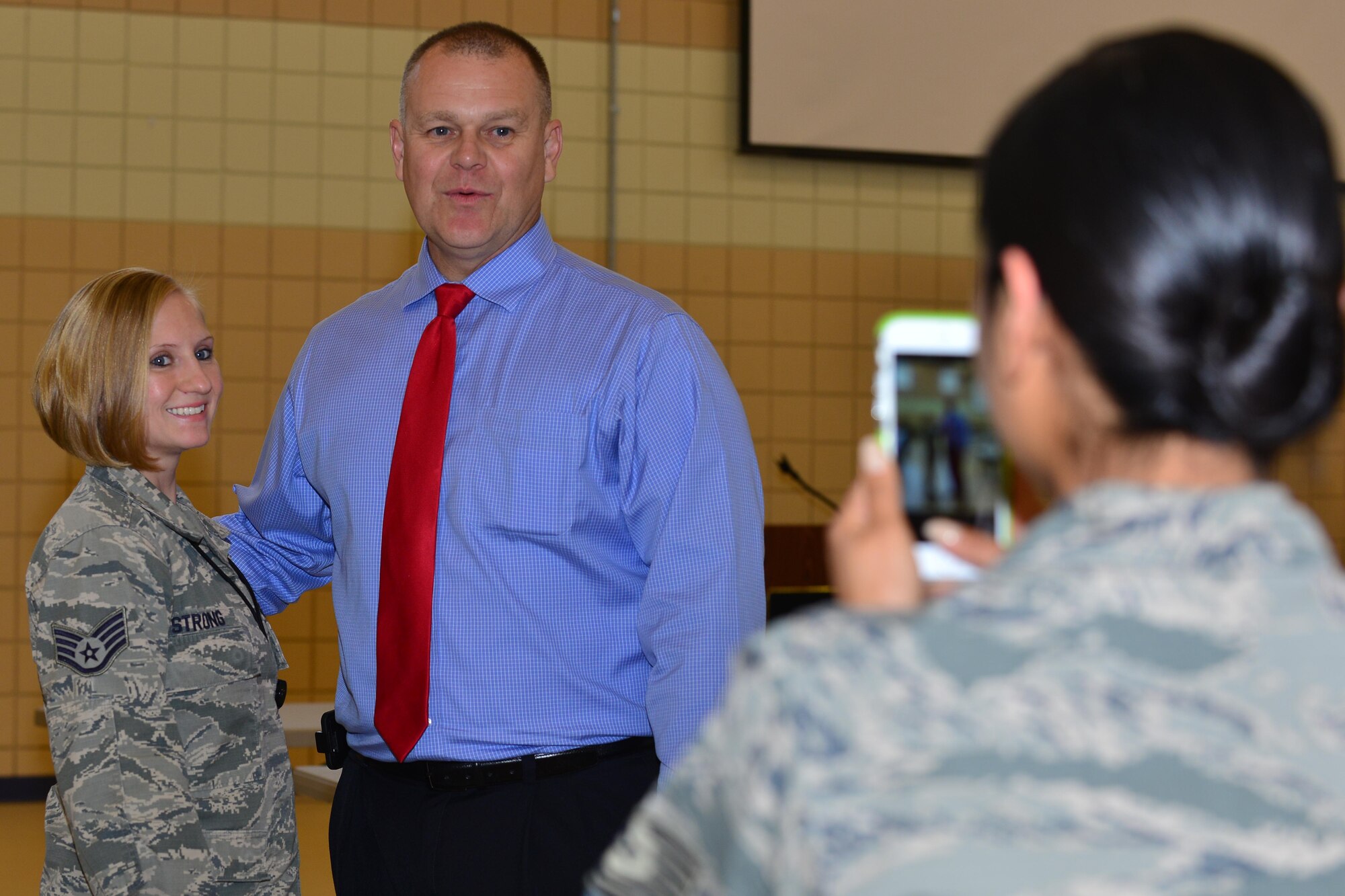 Retired Chief Master Sgt. of the Air Force James Roy takes a photo with U.S. Air Force Staff Sgt. Kimberly Strong 363rd Intelligence Surveillance and Response Wing executive assistant, at Langley Air Force Base, Va., May 20, 2015. Roy spoke with noncommissioned officers including Strong at a roundtable where they asked questions about the Air Force and its future. (U.S. Air Force photo by Staff Sgt. Natasha Stannard/Released)