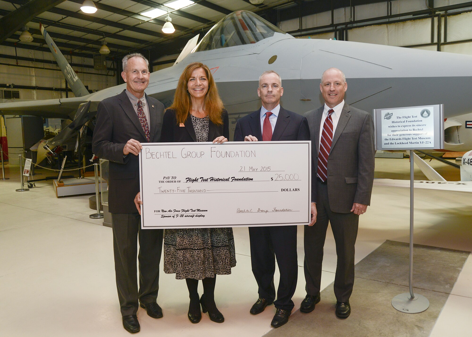 Bechtel Corporation presented a check for $25,000 to the Flight Test Historical Foundation at the Air Force Flight Test Museum May 21 to sponsor the YF-22A. (Left to right) Dr. David Smith, 412th Test Wing Installation Support director, and Lisa Gray, FTHF chairwoman, accepted the donation from Brian Sheridan and Dr. Richard Tighe from Bechtel. (U.S. Air Force photo by Rebecca Amber)