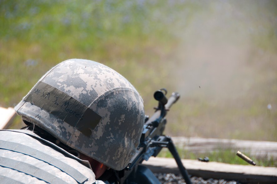 Staff Sgt. Jon Moores, Security Forces Squadron installation entry controller, trains in the use of the M249 automatic rifle at Fort Chaffee Joint Maneuver Training Center, Ark., May 2, 2015. The M249 fires 800 rounds per minute. (U.S. Air National Guard photo by Senior Airman Cody Martin/Released)