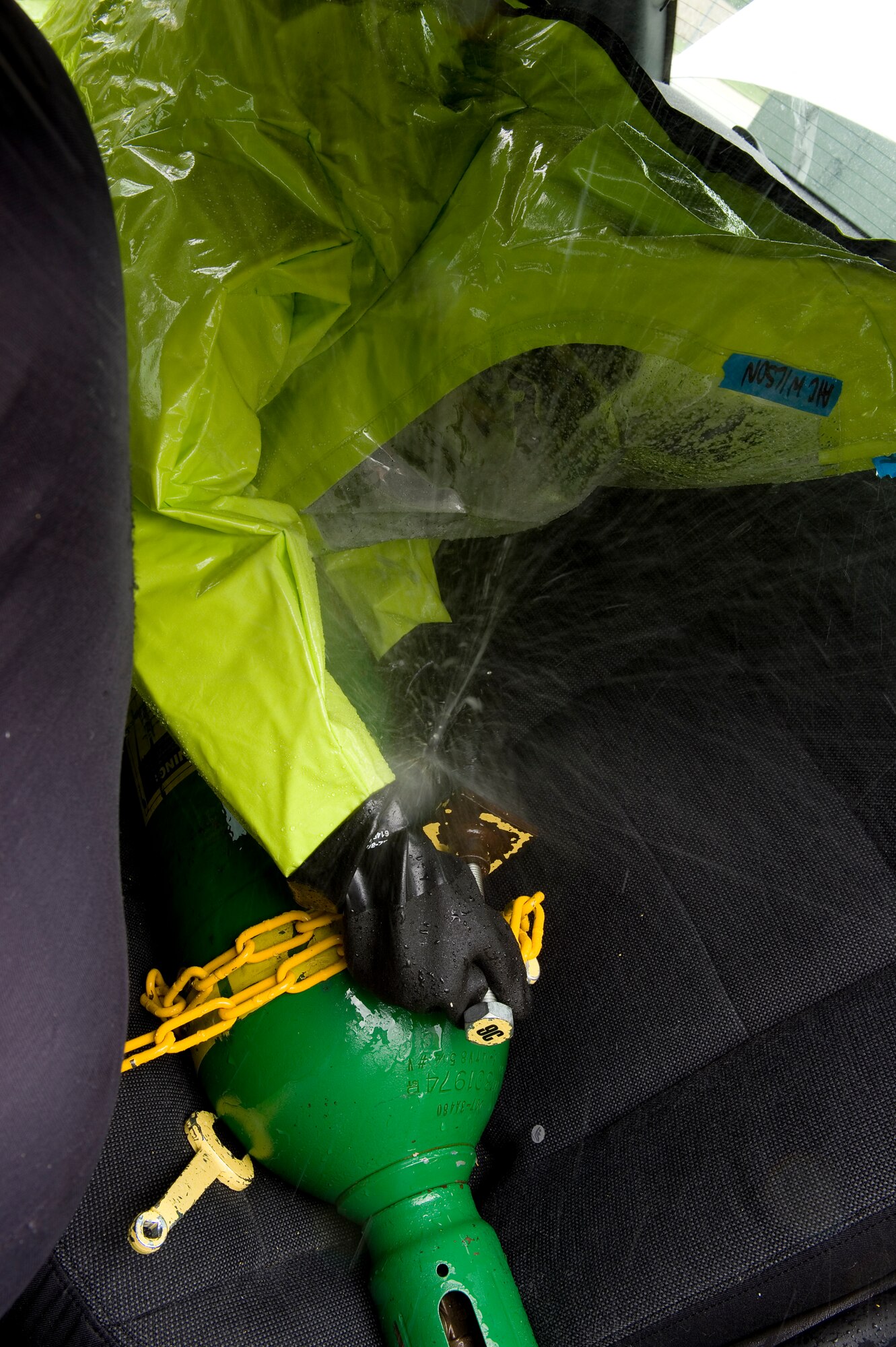 Airman 1st Class Simone Wilson, 319th Civil Engineer Squadron emergency management specialist from Grand Forks Air Force Base, North Dakota, attempts to seal a leaking cylinder during a chemical, biological, radiological, nuclear and enhanced conventional weapons training exercise at Grissom Air Reserve Base, Ind., May 19, 2015. The exercise was part of a 10-day course that allowed EM specialists from five major commands to unite and hone EM principals while incorporating combat skills and obtaining mandated recertifications. (U.S. Air Force photo/Tech. Sgt. Benjamin Mota)