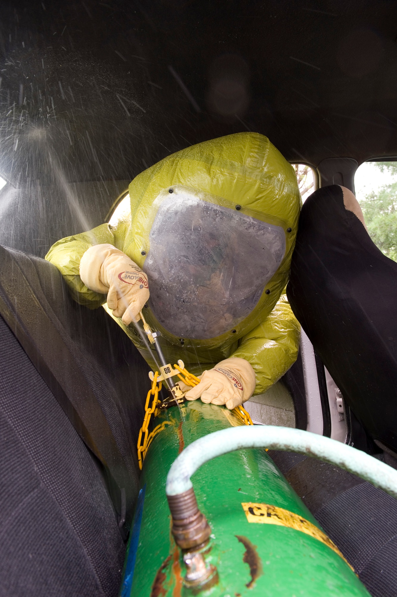 Staff Sgt. Mitchell Birdsong, 60th Civil Engineer Squadron emergency management specialist from Travis Air Force Base, Calif., tightens a clamp on a leaking cylinder during a chemical, biological, radiological, nuclear and enhanced conventional weapons training exercise at Grissom Air Reserve Base, Ind., May 19, 2015. The 10-day course allowed EM specialists from five major commands to unite and hone EM principals while incorporating combat skills and obtaining mandated recertifications. (U.S. Air Force photo/Tech. Sgt. Benjamin Mota)