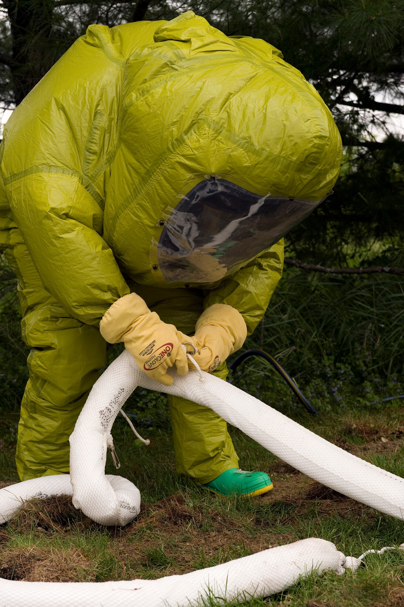 Staff Sgt. Mitchell Birdsong, 60th Civil Engineer Squadron emergency management specialist from Travis Air Force Base, Calif., places containment barriers during a chemical, biological, radiological, nuclear and enhanced conventional weapons training exercise at Grissom Air Reserve Base, Ind., May 19, 2015. The exercise was part of a 10-day course that allowed EM specialists from five major commands to unite and hone EM principals while incorporating combat skills and obtaining mandated recertifications. (U.S. Air Force photo/Tech. Sgt. Benjamin Mota)