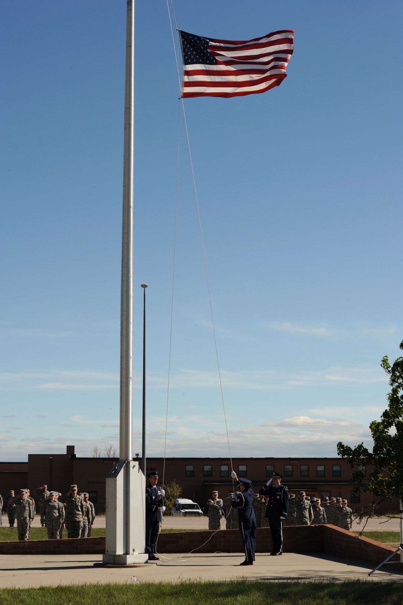 The 28th Bomb Wing Honor Guard lowers the flag during a Memorial Day retreat ceremony at Ellsworth Air Force Base, S.D., May 21, 2015. Memorial Day is observed on the last Monday of May to pay respect to servicemembers who have perished in the line of duty. (U.S. Air Force photo by Senior Airman Hailey R. Staker/Released) 