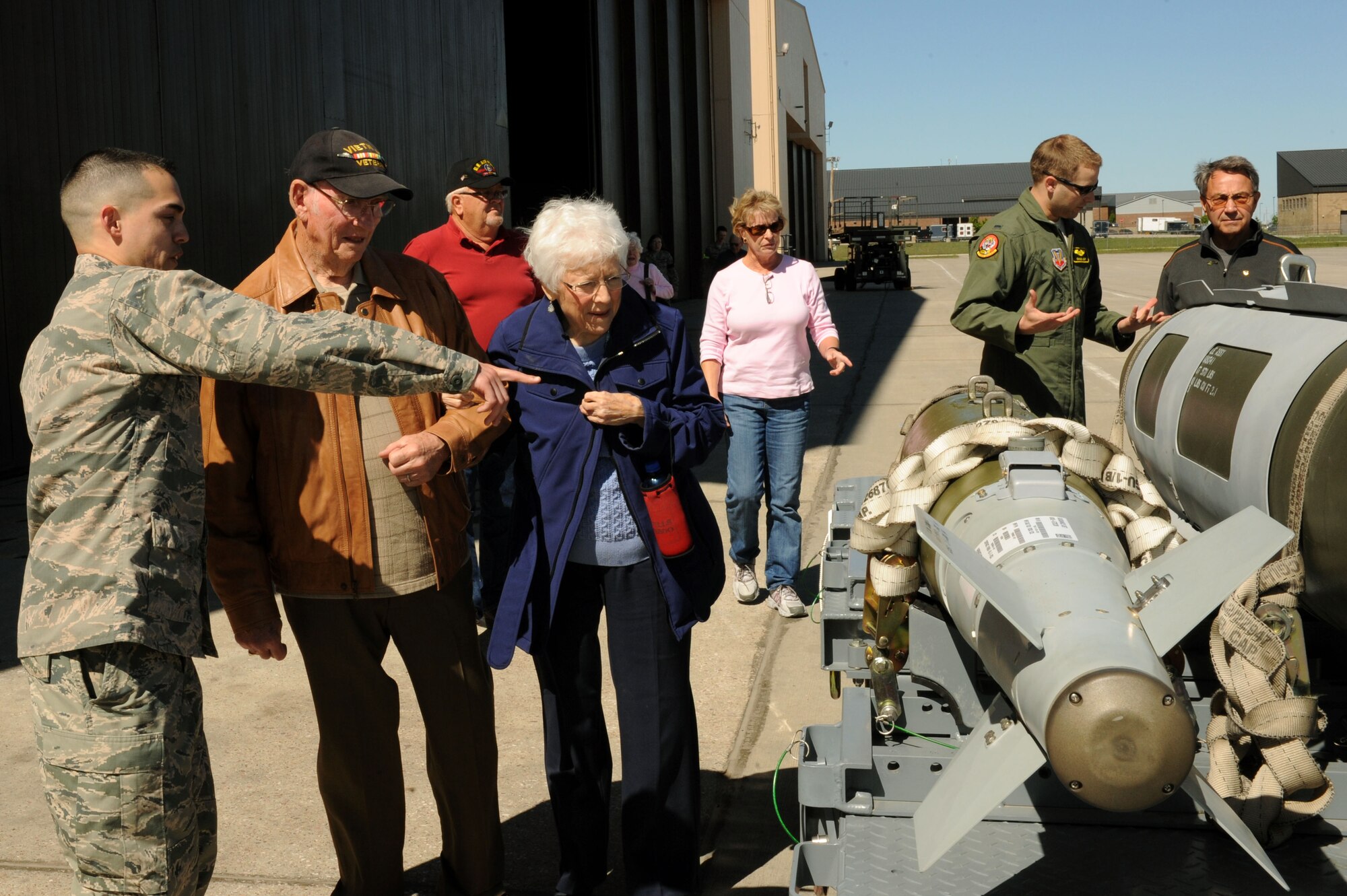 First Lt. Seth Cross, 28th Maintenance Squadron aircraft maintenance officer, explains the GBU-38 and GBU-31 munitions displays to Vietnam War veterans and their spouses at Ellsworth Air Force Base, S.D., May 21, 2015. The event brought together active-duty Airmen with veterans of past generations to commemorate those who have made the ultimate sacrifice. (U.S. Air Force photo by Senior Airman Hailey R. Staker/Released)