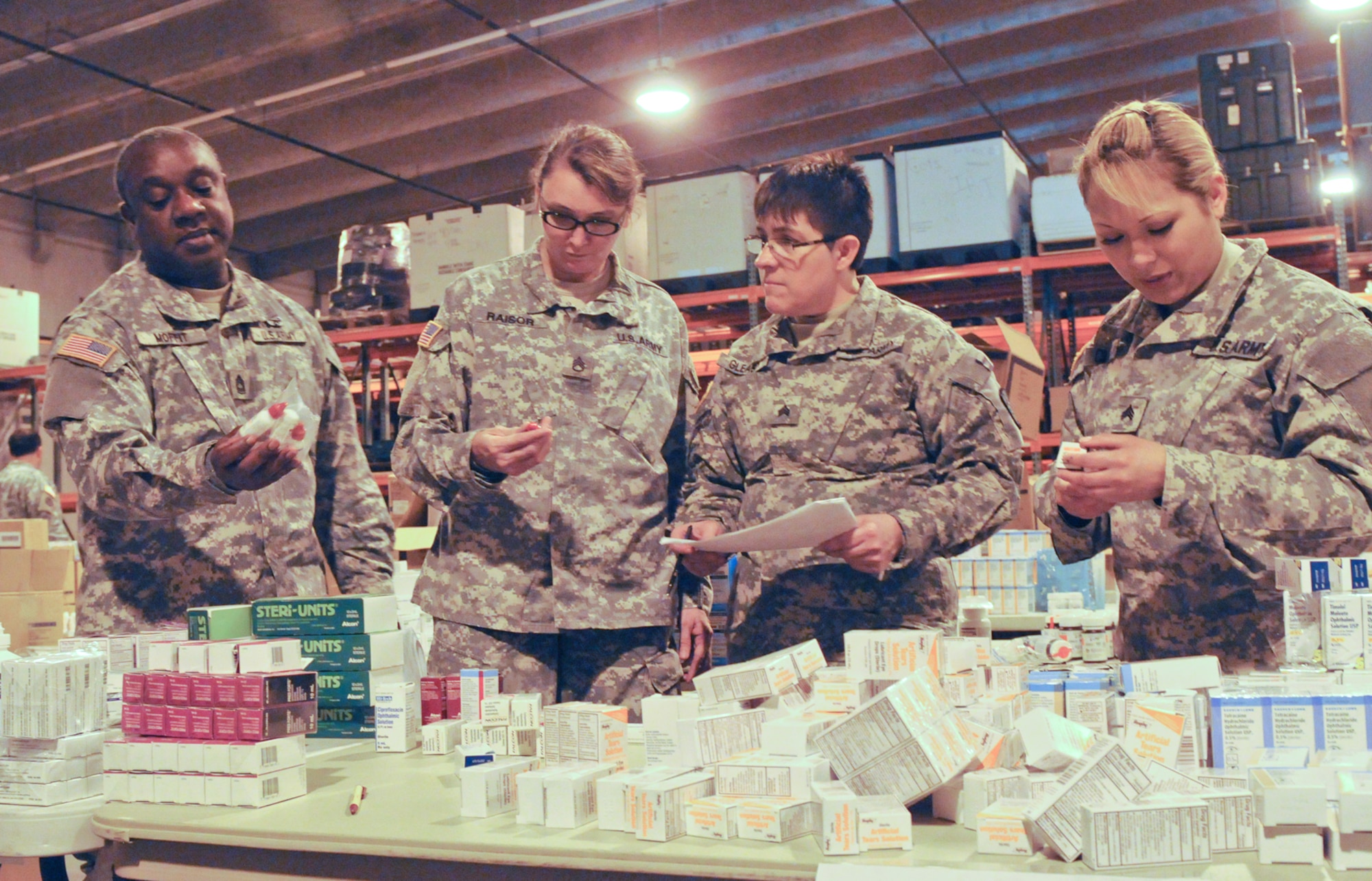 From left, Master Sgt. Michael Moffit, Staff Sgt. Ann Raisor, Sgt. Darlene Gleason and Sgt. Elizabeth Cillian, members of the Army Reserve???s 7241st Medical Support Unit stationed in Lexington, Ky., prepare equipment for an Innovative Readiness Training mission at the 99th Regional Support Command???s medical storage and maintenance facility on Joint Base McGuire-Dix-Lakehurst, N.J. This facility provides a 60,000-square-foot, solar-powered, climate-controlled facility that offers the 3rd Medical Deployment Support Command storage space for medical, dental, veterinary, forward surgical and early entry hospital equipment, as well as maintenance capabilities for bio-medical equipment and X-ray, ventilator and defibrillator repair. (U.S. Army photo by Sgt. 1st Class Raymond Moore/Released)