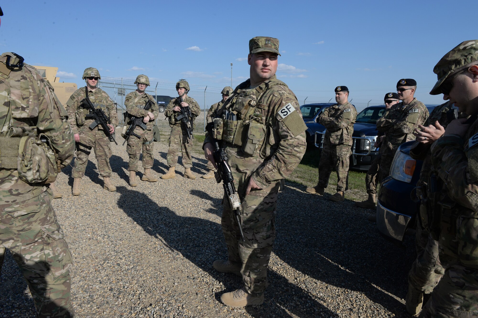 Capt. Brian Ludwig, of the 219th Security Forces Squadron, wearing the visible SF on his shoulder, conducts a briefing at the conclusion of a training exercise at a Minot Air Force Base, North Dakota, launch facility May 20, 2015. The exercise included an intermingled combination of North Dakota Air National Guard members doing their annual training and 91st Missile Security Forces Squadron members performing their day-to-day duties. The Air National Guard members are routinely integrated among the U.S. Air Force active duty personnel as they perform the real-World mission of missile field security in a seamless and indistinguishable manner. (U.S. Air National Guard photo by Senior Master Sgt. David H. Lipp/Released)