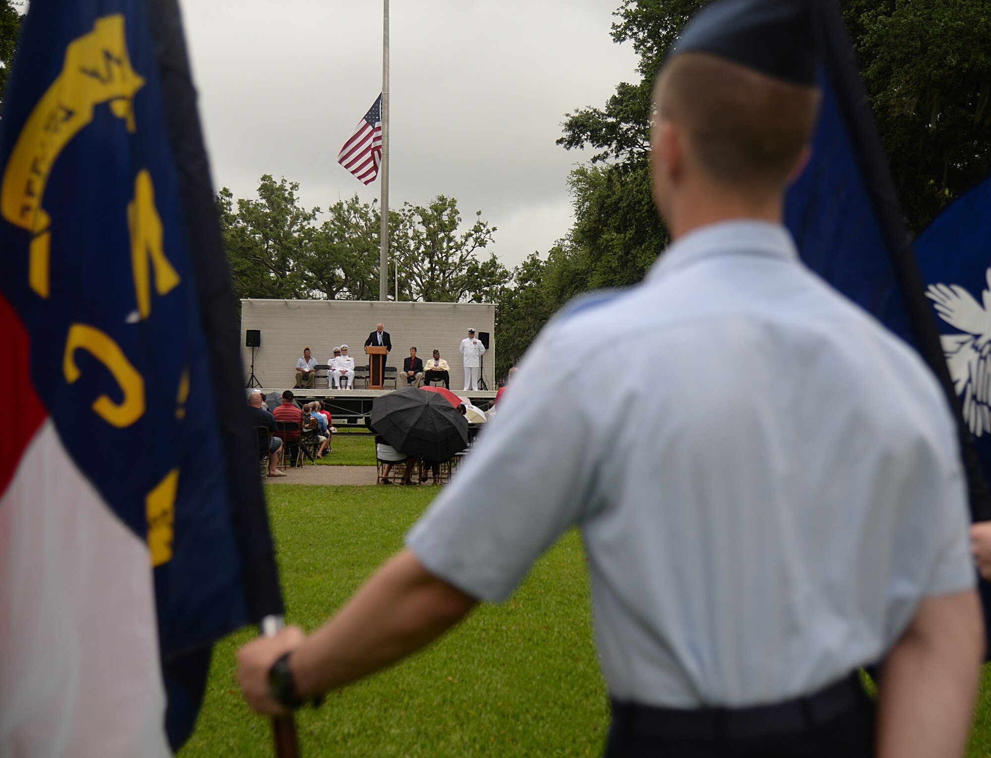 An 81st Training Group Airman holds a state flag at the 2015 Biloxi National Cemetery Memorial Day ceremony, May 25, 2015, Biloxi, Miss. Local veterans, family members and Keesler Air Force Base and Naval Construction Battalion Center leadership attended to honor and remember the lives of fallen U.S. military heroes. (U.S. Air Force photo by Senior Airman Holly Mansfield)