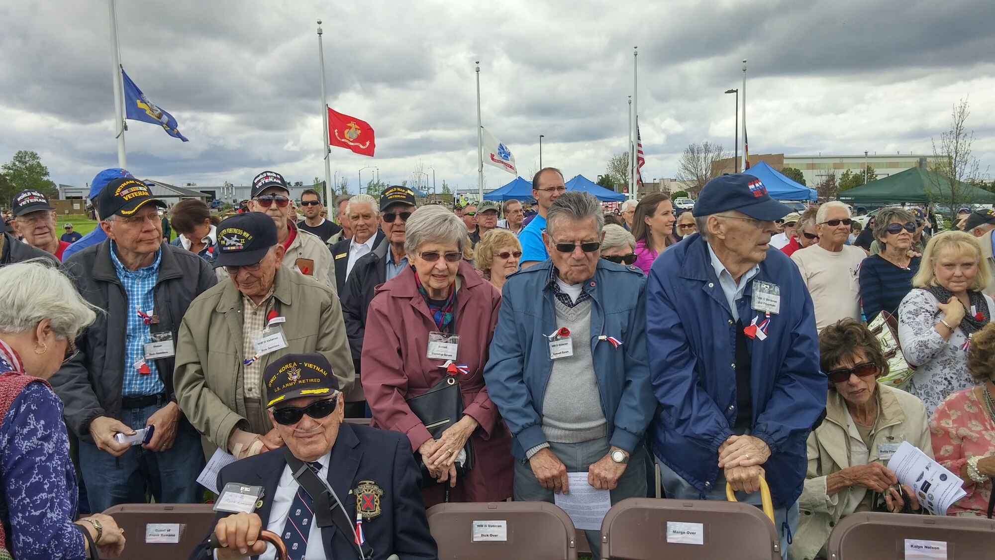 World War II veterans stand to be recognized during the Memorial Day ceremony May 23, 2015, at the Colorado Freedom Memorial in Aurora, Colorado. This year’s ceremony had multiple guest speakers, flyovers, military displays and also marked the 70th anniversary of the end of World War II. (courtesy photo)
