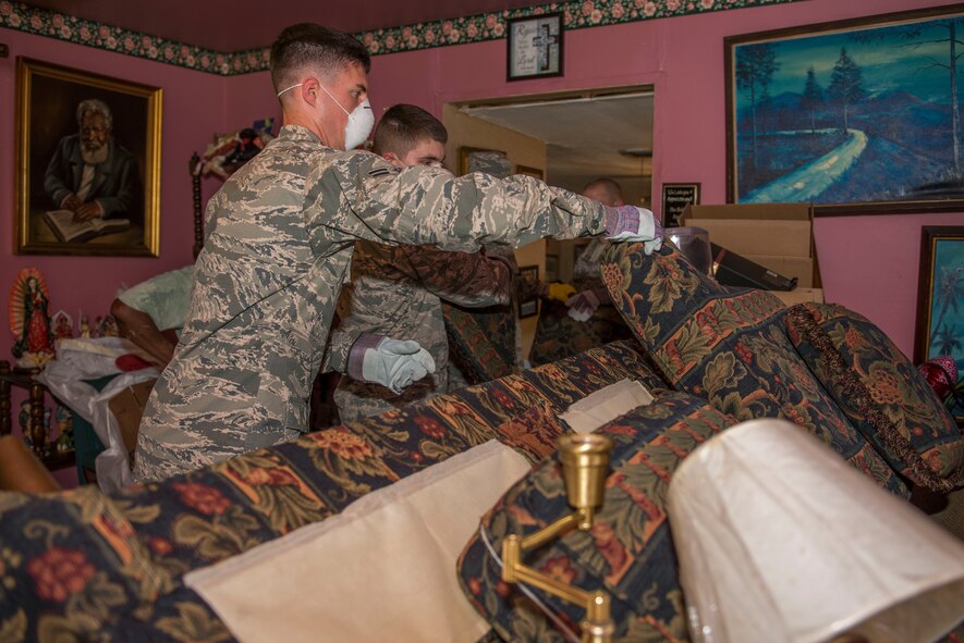 U.S. Air Force Airmen from Sheppard Air Force Base, Texas, help move furniture from homes that were damaged from flooding in Wichita Falls, May 26, 2015. Airmen worked side-by-side with United Way and Red Cross to help the local community recover from flood damage. (U.S. Air Force photo by Senior Airman Kyle Gese/Released)
