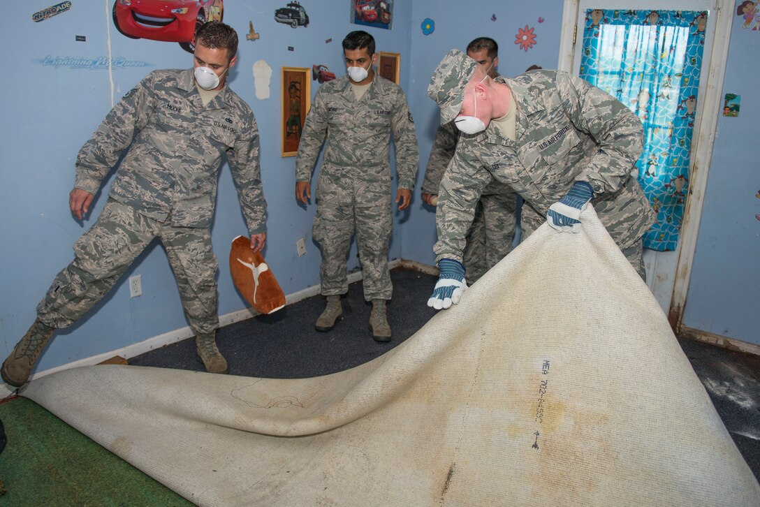 U.S. Air Force Airmen from Sheppard Air Force Base, Texas, help remove carpet from a home damaged from flooding in Wichita Falls, May 26, 2015. Airmen volunteered on multiple occasions to help in the community. (U.S. Air Force photo by Senior Airman Kyle Gese/Released)