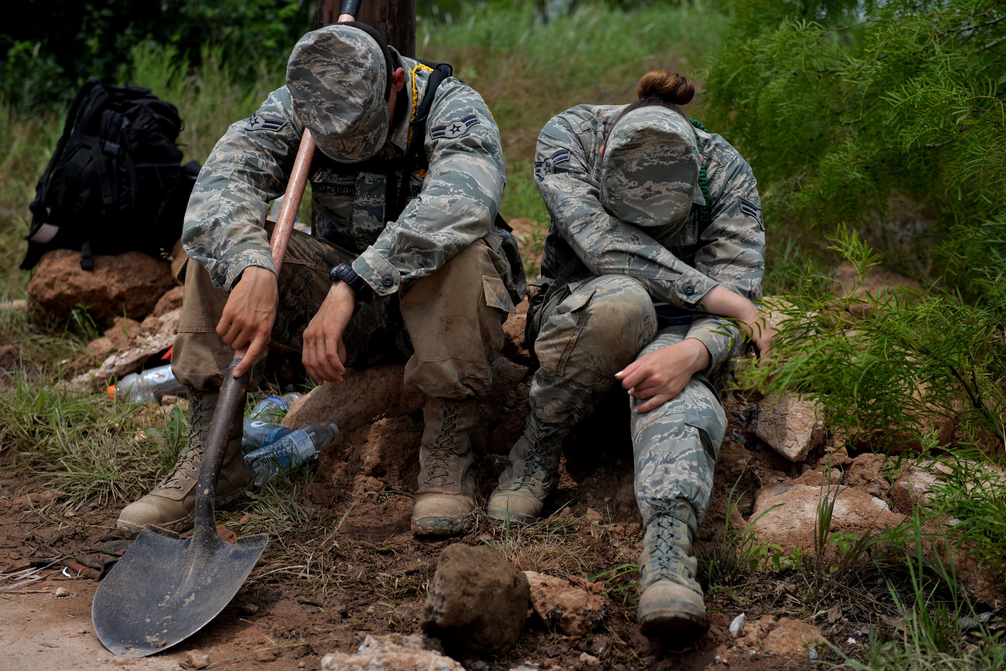 U.S. Air Force Airman 1st Class Lawrence Guzzardo, 362nd Training Squadron Airman in Training and native of Albuquerque N.M., and Airman 1st Class Michelle Lee, 362nd TRS AiT and native of Feura Bush N.Y., rest after filling sandbags to help the local community prepare for potential flooding in Wichita Falls, Texas, May 23, 2015. Airmen also aided in loading them to trucks for people to use in an effort to prevent flood damage. (U.S. Air Force photo by Senior Airman Kyle Gese/Released)