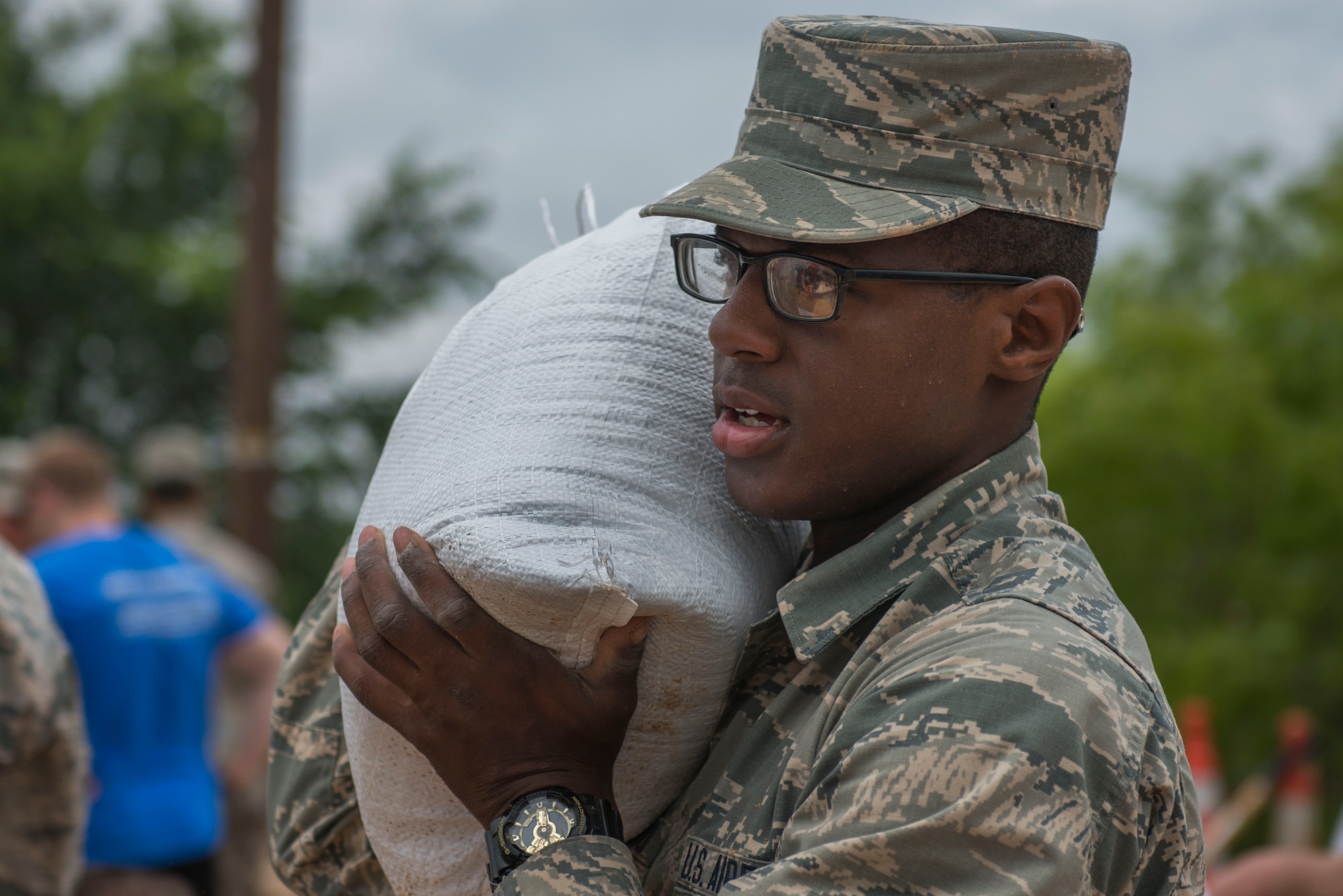 U.S. Air Force Airman Roger Presswood, 362nd Training Squadron Airman in Training and native of Chicago, carries a sandbag to be loaded onto a truck to help the local community prepare for a potential flood in Wichita Falls, Texas, May 23, 2015. Presswood volunteered with more than 100 other Airmen to help the community in a time of need. (U.S. Air Force photo by Senior Airman Kyle Gese/Released)