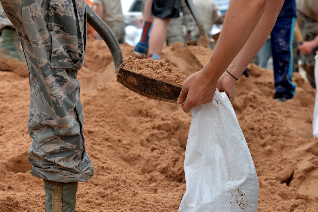 U.S. Air Force Airmen in Training from Sheppard Air Force Base, Texas, volunteer to help the community fill sandbags in preparation for potential flooding in Wichita Falls, May 23, 2015. Airmen also aided in loading them to trucks for people to use in an effort to prevent flood damage. (U.S. Air Force photo by Senior Airman Kyle Gese/Released)