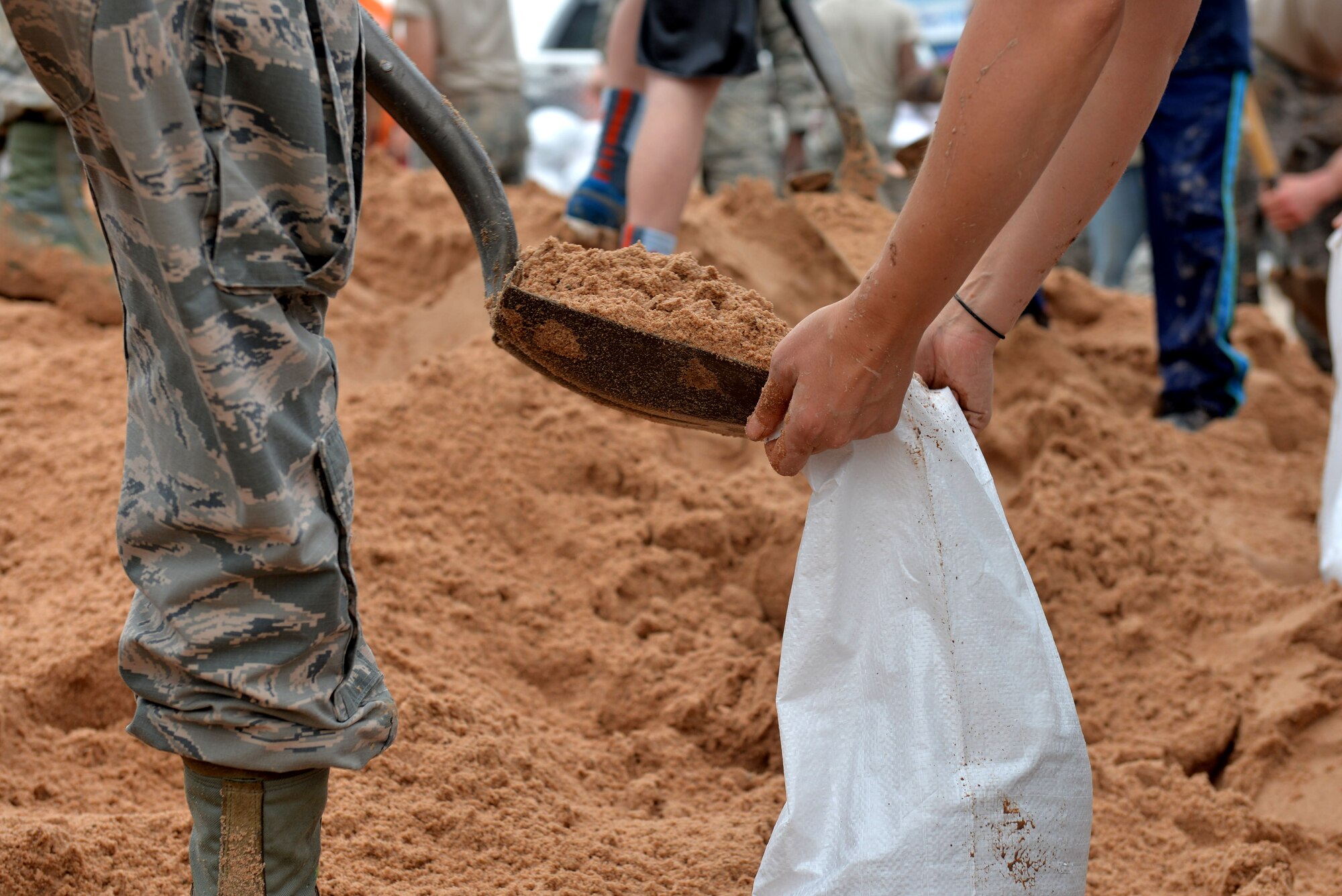 U.S. Air Force Airmen in Training from Sheppard Air Force Base, Texas, volunteer to help the community fill sandbags in preparation for potential flooding in Wichita Falls, May 23, 2015. Airmen also aided in loading them to trucks for people to use in an effort to prevent flood damage. (U.S. Air Force photo by Senior Airman Kyle Gese/Released)