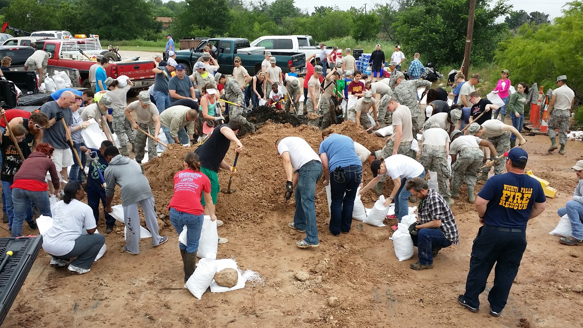 U.S. Air Force Airmen in Training from Sheppard Air Force Base, Texas, volunteer to help the community fill sandbags in preparation for potential flooding in Wichita Falls, May 23, 2015. More than 100 Airmen helped fill sandbags on rotational shifts throughout the day. (U.S. Air Force photo by Senior Airman Kyle Gese/Released)