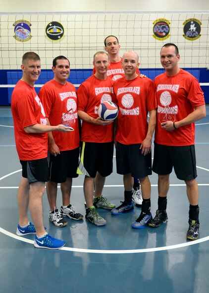 The United States Air Force Warfare Center volleyball team poses with the trophies and T-shirts awarded to the Schriever Air Force Base Intramural Volleyball Champions following their straight set victory against the 6th Space Operations Squadron Thursday. The team won both the regular season and post season titles. (U.S. Air Force photo/Christopher DeWitt)