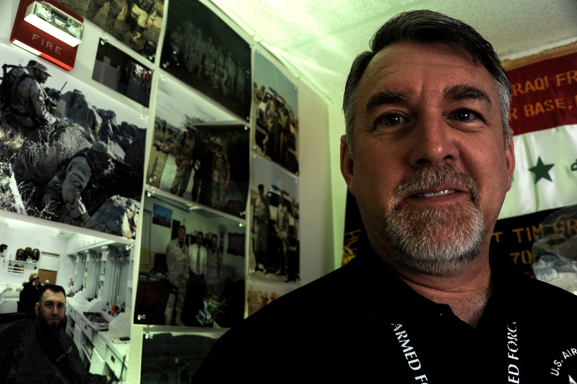 Tim Griggs, 42nd Medical Group recovery care coordinator, is surrounded by photos depicting his 27-year Air Force career, May 21, 2015, Maxwell Air Force Base, Alabama. Before becoming a recovery care coordinator, Griggs served in the Air Force for 27 years, spending 24 years working in security forces and three years as a Senior NCO Academy instructor. (U.S. Air Force photo by Airman 1st Class Alexa Culbert)