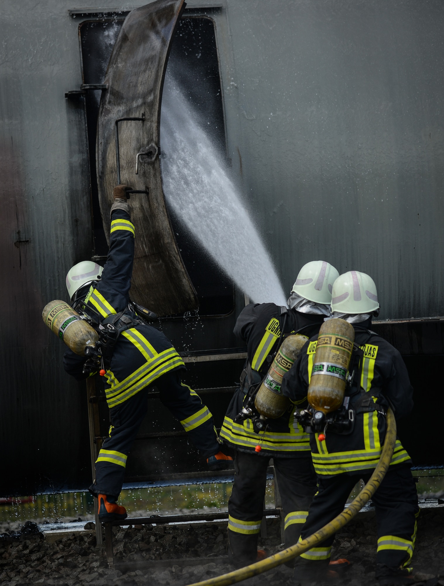 Lithuanian Air Force firefighters prepare for a simulated aircraft fire during a NATO Firefighter Fundamentals course May 20, 2015, at Ramstein Air Base, Germany. Instructors from the 435th Construction and Training Squadron lead a team of more than 20 firefighters through scenarios that included confined-space rescue, structural collapse, aircraft and structural firefighting, crash recovery and incident command system training. (U.S. Air Force photo /Senior Airman Nicole Sikorski)