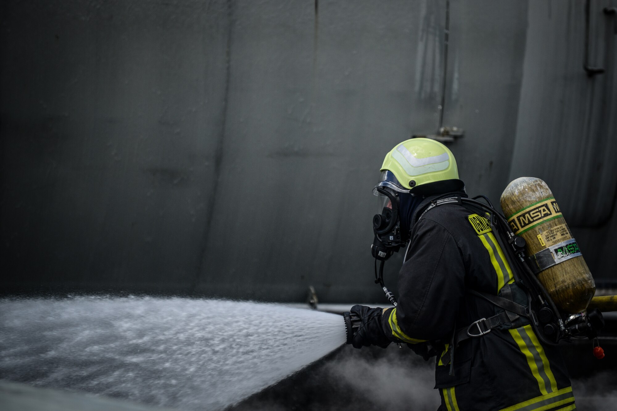 A Lithuanian firefighter extinguishes a simulated aircraft fire during a NATO Firefighter Fundamentals course May 20, 2015, at Ramstein Air Base, Germany. Instructors from the 435th Construction and Training Squadron, lead a team of more than 20 firefighters through scenarios that included confined-space rescue, structural collapse, aircraft and structural firefighting, crash recovery and incident command system training. (U.S. Air Force photo /Senior Airman Nicole Sikorski)