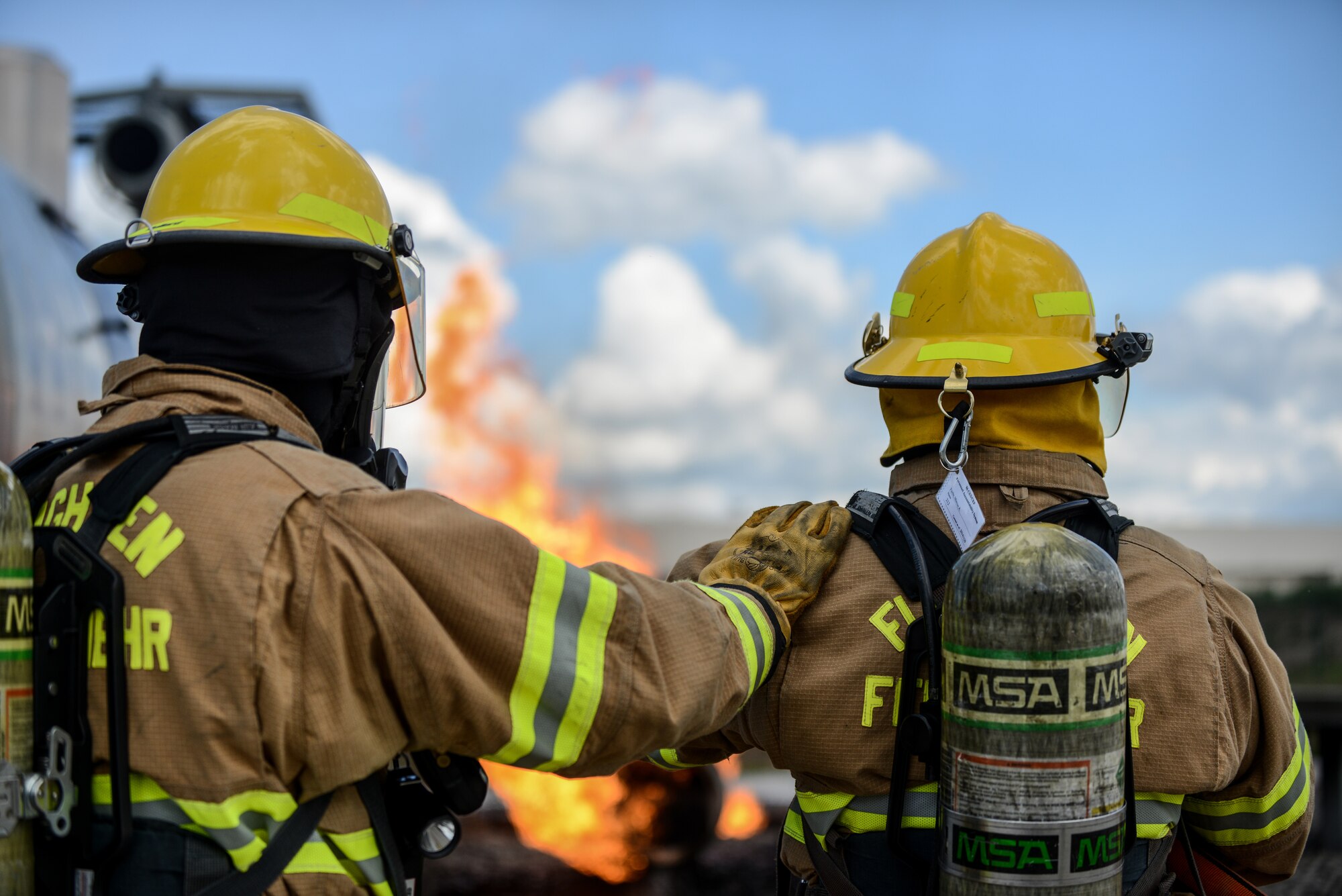 Lithuanian Air Force firefighters watch a simulated aircraft fire during a NATO Firefighter Fundamentals course May 20, 2015, at Ramstein Air Base, Germany. Instructors from the 435th Construction and Training Squadron, lead a team of more than 20 firefighters through scenarios that included confined-space rescue, structural collapse, aircraft and structural firefighting, crash recovery and incident command system training. (U.S. Air Force photo /Senior Airman Nicole Sikorski)