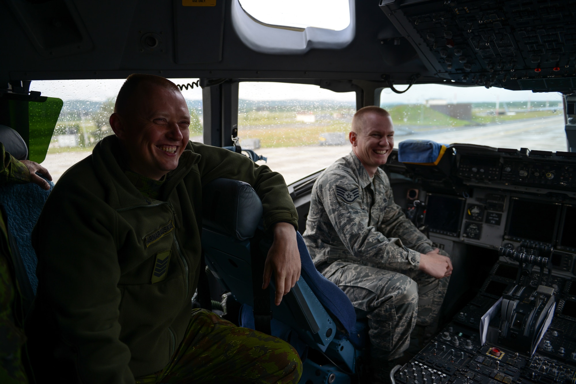 Staff Sgt. Valdas Parnarauskas, Lithuanian fire and rescue section commander, and a U.S. Air Force Airman tour the cockpit of a C-17 Globemaster III. More than 20 firefighters from the Lithuanian Air Force Fire Department attended the five-day course which taught them how to respond to NATO aircraft mishaps that involve both cargo and fighter aircraft.  (U.S. Air Force photo /Senior Airman Nicole Sikorski)