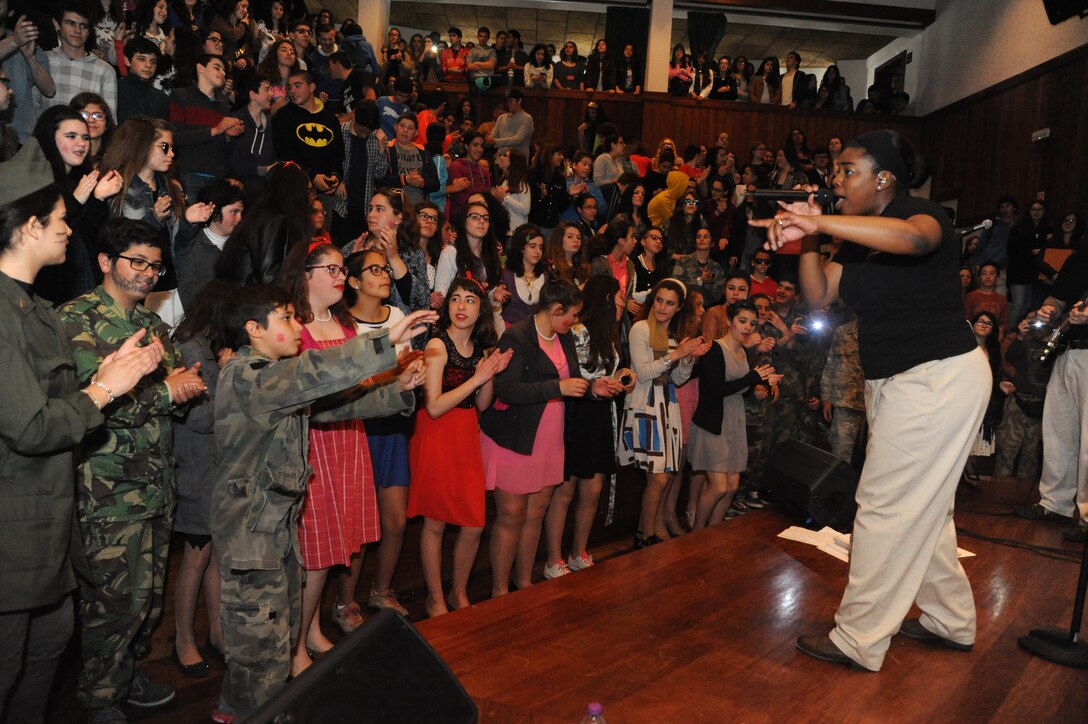 The U.S. Air Forces in Europe Band’s music group, Touch n’ Go performed at numerous locations across the island of Terceira as part of community outreach efforts,  April 23-26, 2015. The performances allowed the Air Force to connect with members of the community to thank them for their support over the years. This photo features Senior Airman Paula Hunt entertaining students at Praia High School. (U.S. Air Force photo by Mr. Guido Melo)