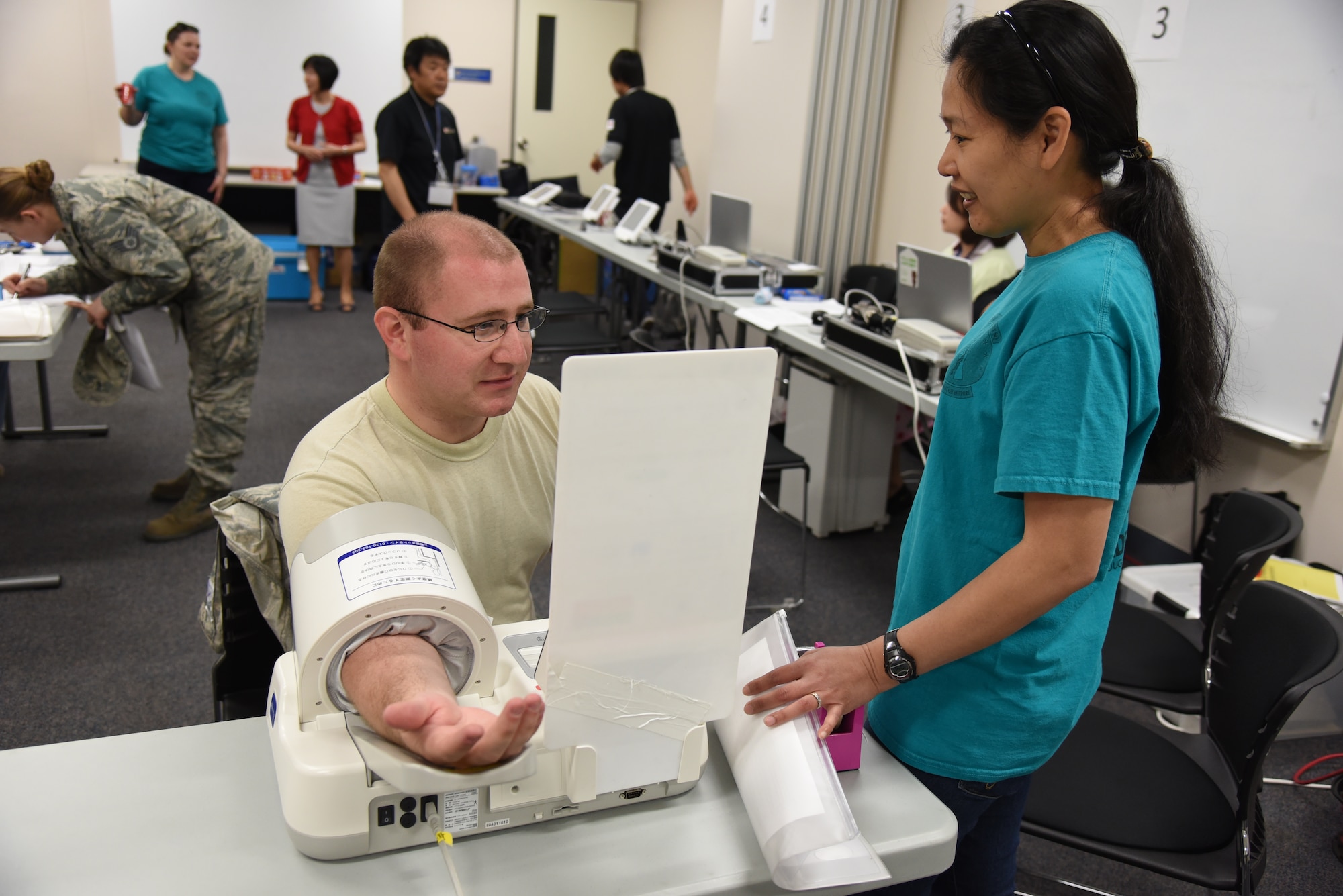 U.S. Air Force Staff Sgt. Steven Main, 35th Communications Squadron NCO in charge of server management, has his blood pressure tested by Tech. Sgt. Grace Hodge, 35th Medical Surgical Squadron NCOIC of transfusion services, during a blood drive at Misawa Air Base, Japan, May 27, 2015. Prior to having blood drawn, patients are pre-screened for blood pressure and medical history. (U.S. Air Force photo by Senior Airman Patrick S. Ciccarone/Released)