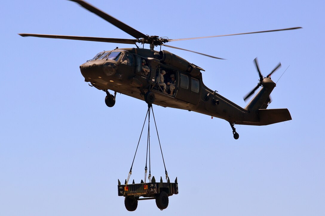 A UH-60L Black Hawk helicopter transports a tactical vehicle trailer during slingload 
training on Camp Carroll, Waegwan, South Korea, May 21, 2015. The helicopter crew is assigned to C Company, 2nd Battalion, 2nd Aviation Regiment.