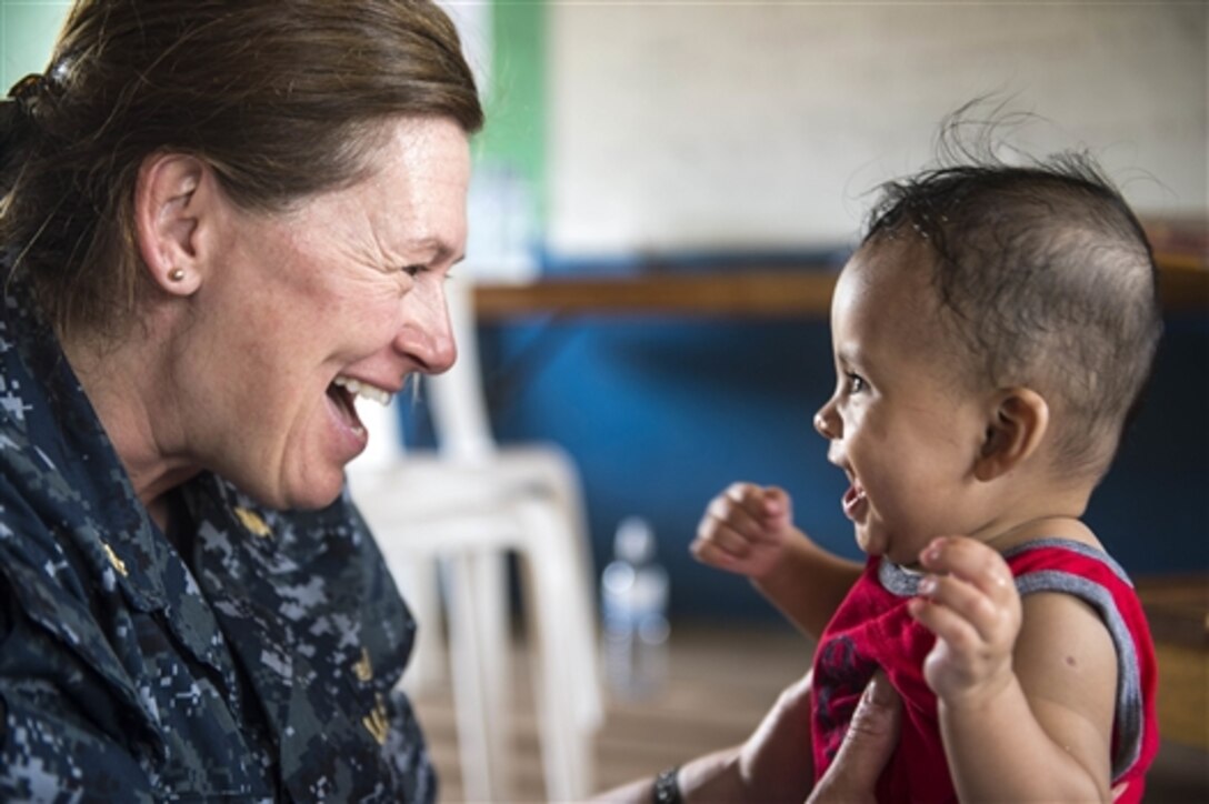 U.S. Navy Lt. Cmdr. Carrie Dreyer, a physical therapist, interacts with a baby in Puerto Cabezas, Nicaragua, during a Continuing Promise 2015 medical event, May 24, 2015. Continuing Promise is a U.S. Southern Command-sponsored deployment to conduct civil-military operations and show U.S. support and commitment to Central and South America and the Caribbean. Dreyer is assigned to Walter Reed National Military Medical Center in Bethesda, Md.