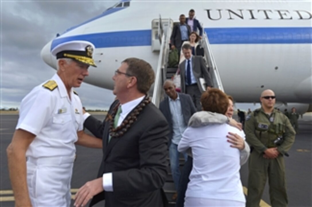 Commander, U.S. Pacific Command, Navy Adm. Samuel Locklear III, greets Defense Secretary Ash Carter, as he and his wife, Stephanie, arrive in Honolulu, May 26, 2015. The secretary is on a 10-day trip to the Asia-Pacific region with stops in Singapore, Vietnam, and India. 