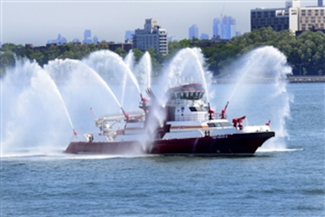 A 343 Fireboat, assigned to the Fire Department of New York Marine 9 division, prepares to escort the guided missile destroyer USS Stout through New York Harbor following Fleet Week New York 2015 in New York, May 26, 2015. This year marked the 27th anniversary of the city's time-honored celebration of the sea services. 