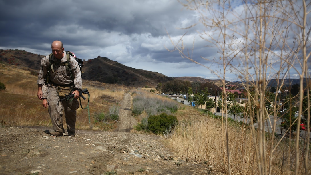 Master Sgt. Vincent Marzi, the operations chief for 1st Force Reconnaissance Company, takes his final steps as he approaches the end of the 7th Annual Recon Challenge aboard Marine Corps Base Camp Pendleton, California, May 15, 2015. After more than 12 hours of events and hiking with a pack, Marzi knew he made Maj. Jeremy Graczyk, a former platoon commander and fallen Marine, proud.