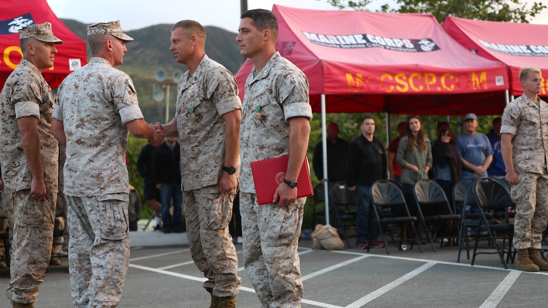 Master Sgt. David Jarvis, a reconnaissance Marine with 1st Reconnaissance Battalion, and Capt. Patrick Zuber, a company commander for 1st Reconnaissance Battalion, are awarded for winning the 7th Annual Recon Challenge aboard Marine Corps Base Camp Pendleton, California, May 15, 2015. The Marines received this honor from Col. Christopher J. Williams, the commanding officer of School of Infantry-West, and Master Gunnery Sgt. Brian Yarolem, the operations chief for Reconnaissance Training Company and event coordinator.