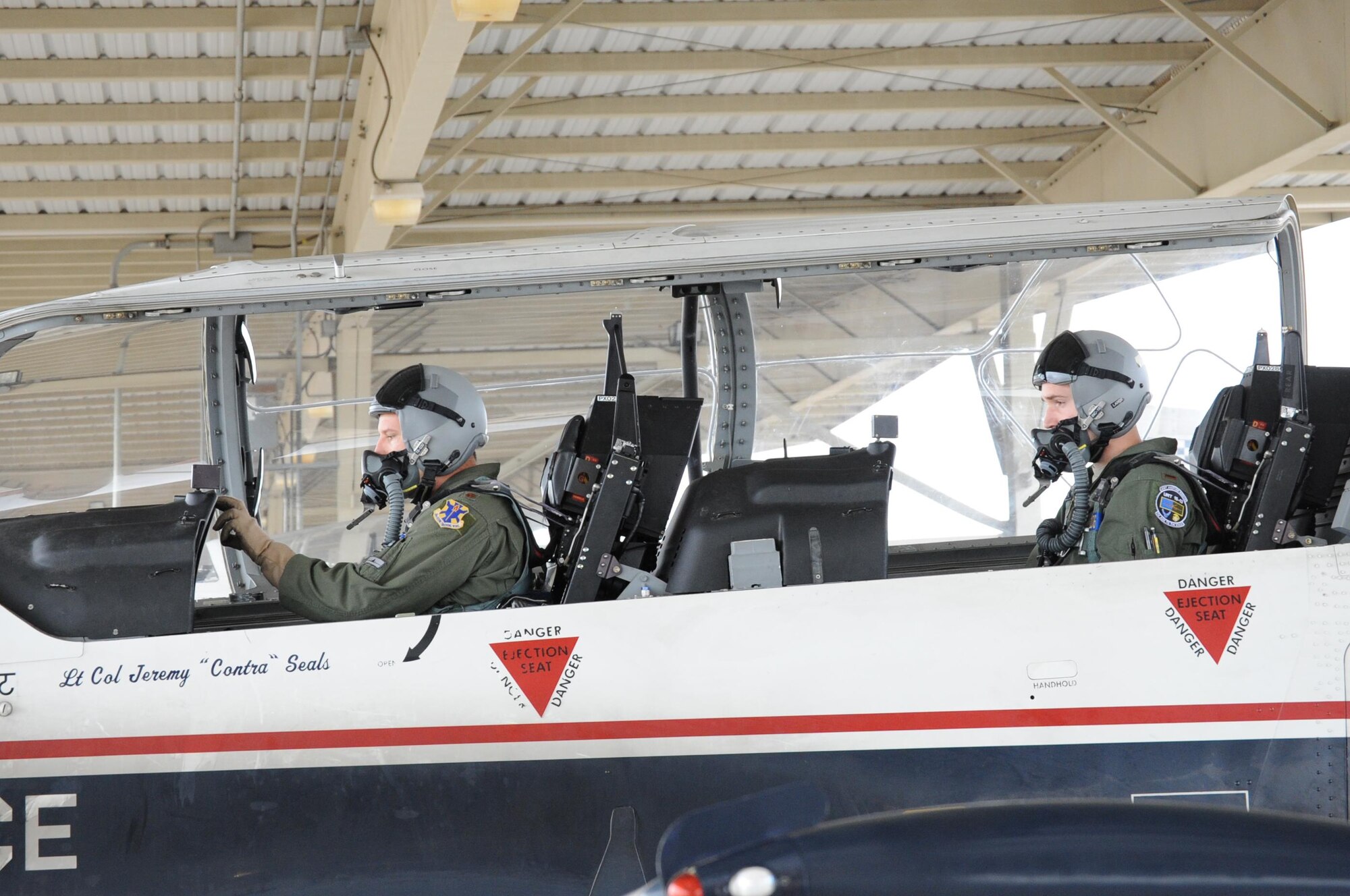 Maj. Todd Salzwedel (left), 559th Flying Training Squadron director of staff, demonstrates final check procedures to a 558th Flying Training Squadron remotely piloted aircraft instrument qualification student, prior to his first orientation flight in a T-6 Texas II May 12 at Joint Base San Antonio-Randolph, Texas. This is the first class to get a real world feel of what manned pilots experience in a combat environment, offers validation of their training and provides a different perspective than what they receive in a simulator. (U.S. Air Force photo by Melissa Peterson)
