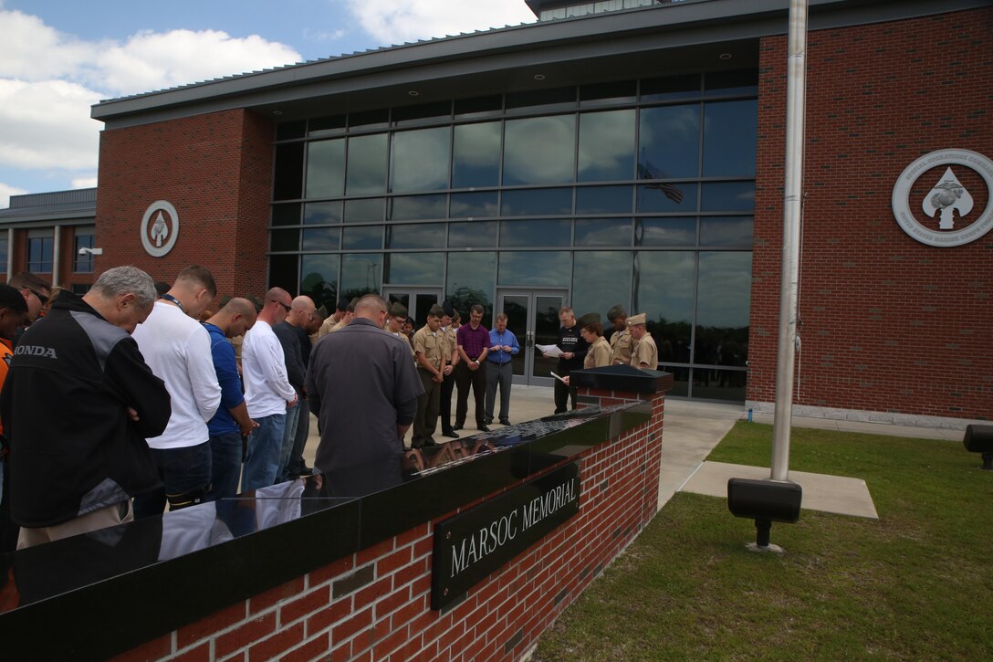 Marines and sailors with Marine Corps Forces Special Operations Command gather at the MARSOC Memorial at Stone Bay aboard Marine Corps Base Camp Lejeune, N.C., to honor fallen service members May 22, 2015. The Marines and sailors rode motorcycles to the Jacksonville National Cemetery following a moment of prayer, reading of the names on the memorial, a moment of silence and a blessing of the bikes to honor all who have served as the Memorial Day weekend commenced. (USMC official photo by Sgt. Donovan Lee/released)