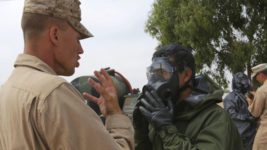 A Royal Moroccan Armed Forces soldier checks his gas mask with U.S. Marine Corps Sgt. Brent Berven, Chemical, Biological Incident Response Force, before he demonstrates a decontamination procedure for the Chemical, Biological, Radiological, and Nuclear defense workshop during Exercise African Lion 15 in Tifnit, Morocco, May 16. The Royal Moroccan, U.S., U.K., Netherlands, and Belgian Armed Forces integrated while conducting peacekeeping support training to improve military capabilities and operational familiarity as one international coalition.