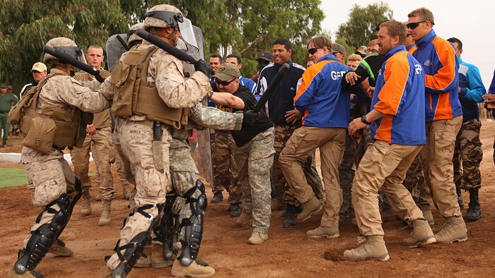 Marines with 2nd Law Enforcement Battalion demonstrate crowd control procedures against group of Moroccan, Dutch and Belgium soldiers acting as an unruly crowd May 20 in the Tifnit, Morocco, training area. Exercise African Lion 15 is an annually-scheduled, combined U.S.–Moroccan exercise designed to improve mutual understanding of each nation’s tactics, techniques and procedures while demonstrating the strong bond between the two nation’s militaries.  The one-week exercise includes various types of military training, including a command post exercise; stability operations, such as nonlethal weapons training and crisis/disaster response training.  Additionally, in February an intelligence capacity building seminar was conducted.
