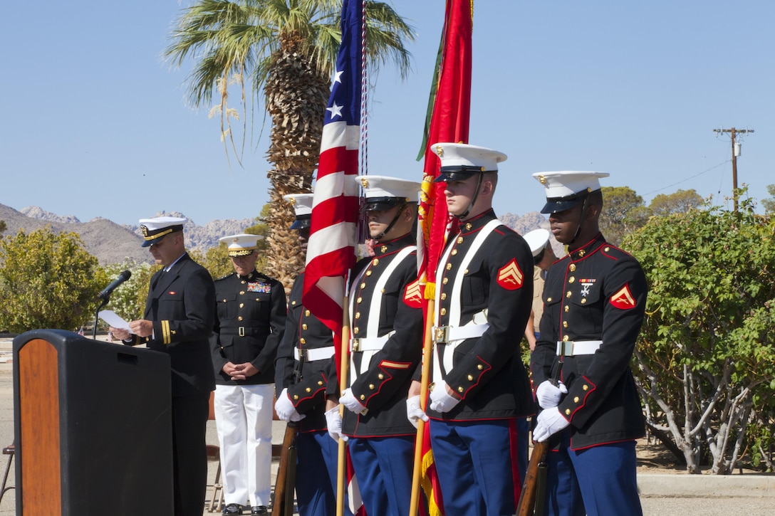 Navy Chaplain Lt. Matt Fisher gives the benediction May 25, 2015, at the Memorial Day Remembrance at the Twentynine Palms Public Cemetery. Next to him are Maj. Gen. Lewis A. Craparotta, Combat Center Commanding General, and the Combat Center Color Guard. (Official Marine Corps photo by Kelly O'Sullivan/Released)