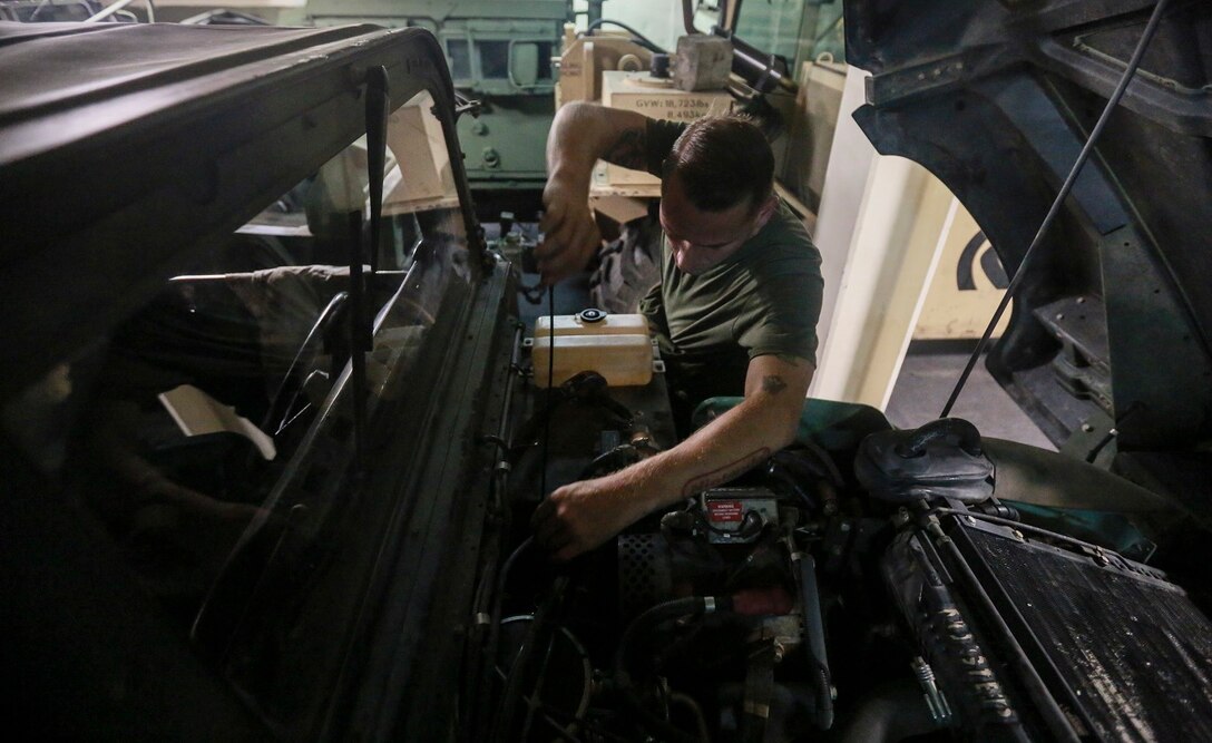 U.S. Marine Sgt. Carl Provost checks the oil on a Humvee aboard the USS Anchorage (LPD 23) at sea in the Pacific Ocean, May 25, 2015. Provost is a motor transportation maintenance chief with the Command Element, 15th Marine Expeditionary Unit. The Marines of the 15th MEU constantly perform maintenance on their equipment to maintain combat readiness. (U.S. Marine Corps photo by Cpl. Steve H. Lopez/Released)