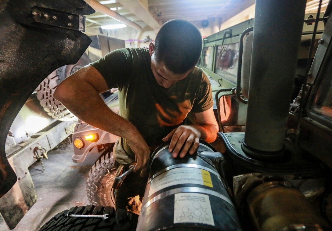 U.S. Marine Cpl. Donald R. Tippie replaces an air filter on a Humvee aboard the USS Anchorage (LPD 23) at sea in the Pacific Ocean, May 25, 2015. Tippie is a motor transportation quality control chief with the Command Element, 15th Marine Expeditionary Unit. The Marines of the 15th MEU constantly perform maintenance on their equipment to maintain combat readiness. (U.S. Marine Corps photo by Cpl. Steve H. Lopez/Released)