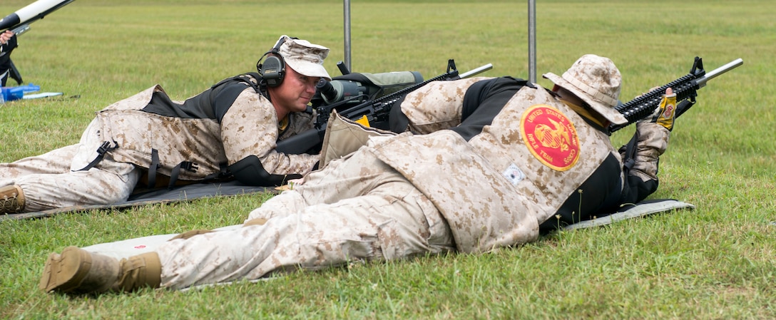 Members of the U.S. Marine Corps Rifle Team communicate during the 1000-yard team match at the 53rd Annual Interservice Rifle Championship hosted by Weapons Training Battalion, Marine Corps Base Quantico Va., July 6, 2014. This was the forty fifth match held since the competition was disrupted in 1968 and 1969 due to a shortage of personnel. (U.S. Marine Corps photo by Cpl. Daniel Benedict/Released) 
