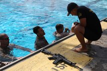 A Marine checks in during one of the two aquatic events during the 7th Annual Recon Challenge aboard Marine Corps Base Camp Pendleton, Calif., May 15, 2015. The competitors not only swam in two events in a pool, but also conducted a 1-kilometer swim in the Pacific Ocean.