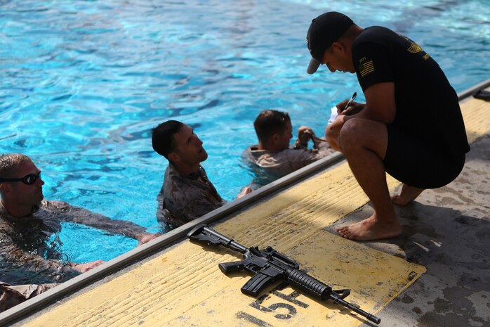 A Marine checks in during one of the two aquatic events during the 7th Annual Recon Challenge aboard Marine Corps Base Camp Pendleton, Calif., May 15, 2015. The competitors not only swam in two events in a pool, but also conducted a 1-kilometer swim in the Pacific Ocean.