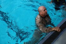 Master Sgt. Vincent Marzi, the operations chief for 1st Force Reconnaissance Company, reassures a corpsman he is fit to continue the 7th Annual Recon Challenge aboard Marine Corps Base Camp Pendleton, Calif., May 15, 2015. Corpsmen were placed throughout the course to ensure the competitors were safe and able to continue.