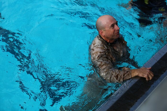 Master Sgt. Vincent Marzi, the operations chief for 1st Force Reconnaissance Company, reassures a corpsman he is fit to continue the 7th Annual Recon Challenge aboard Marine Corps Base Camp Pendleton, Calif., May 15, 2015. Corpsmen were placed throughout the course to ensure the competitors were safe and able to continue.