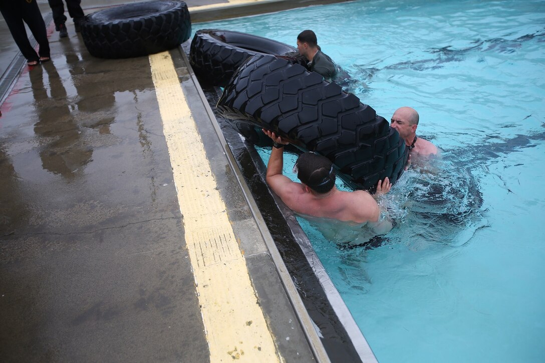 Staff Sgt. David Standridge, a reconnaissance Marine with 1st Reconnaissance Battalion, and Master Sgt. Vincent Marzi, the operations chief for 1st Force Reconnaissance Company, complete their second aquatic event during the 7th Annual Recon Challenge aboard Marine Corps Base Camp Pendleton, Calif., May 15, 2015. The two-man teams were required to sink a tire in the deep end of a pool and later retrieve it.