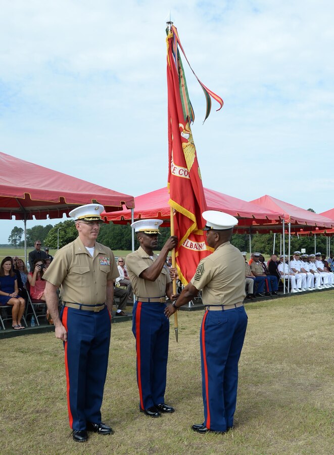 Lt. Col. James C. Carroll III, commanding officer, Marine Corps Logistics Base Albany, passes the unit colors to Sgt. Maj. Kenneth Agee, sergeant major, MCLB Albany, during a change of command ceremony held May 28 on Schmid Field.
