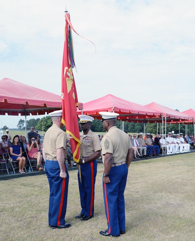 Lt. Col. James C. Carroll III, commanding officer, Marine Corps Logistics Base Albany, receives the unit colors from Col. Don Davis, outgoing commanding officer, MCLB Albany, during a change of command ceremony held May 28 on Schmid Field.